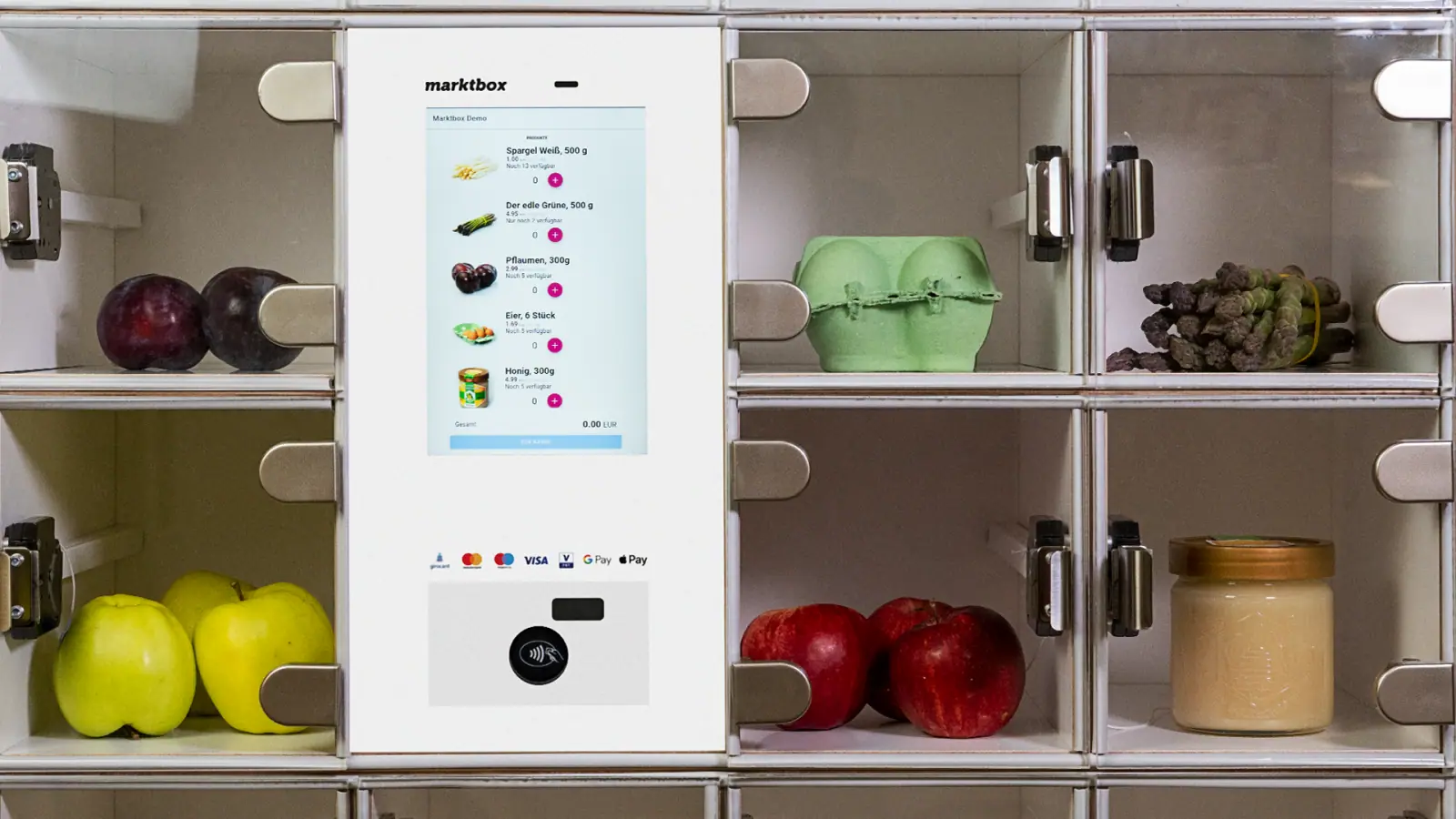 marktbox-Automat mit Touchscreen-Display und transparenten Fächern für frische Lebensmittel wie Obst, Eier und Gemüse